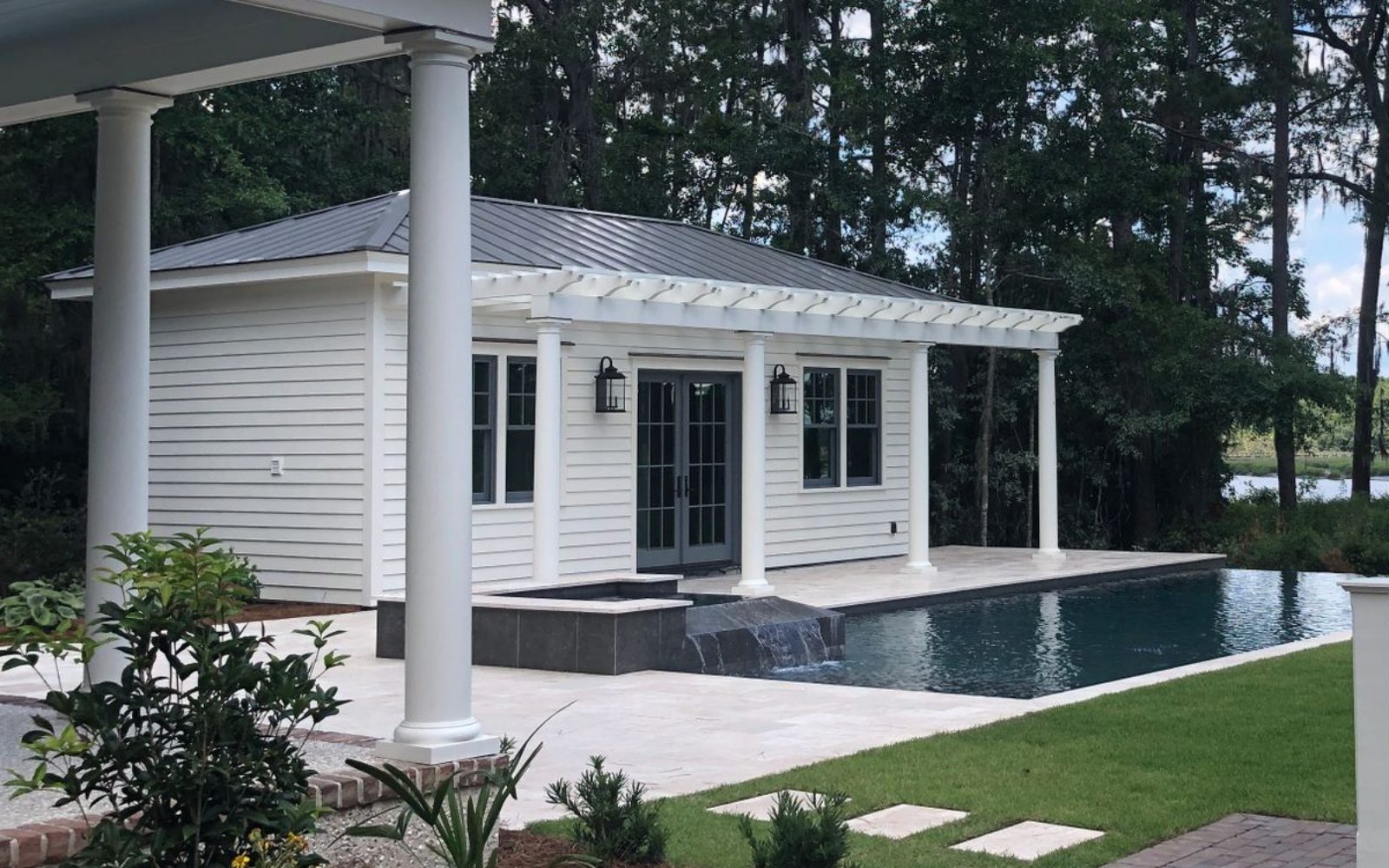 Detached accessory dwelling unit with French doors and a covered porch