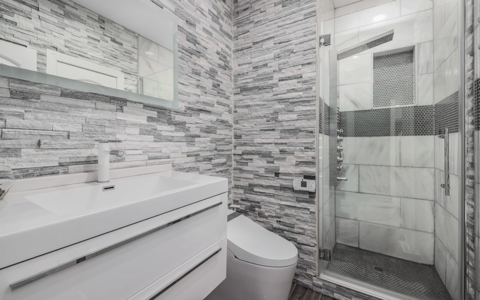 Modern bathroom with a glass shower and tiled walls